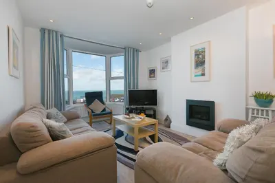 a living room with two couches and a television at SeaCrest 1 in St Ives