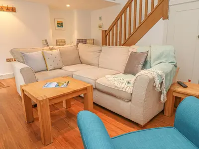 a living room with a couch and a table at Lantern Cottage in Padstow