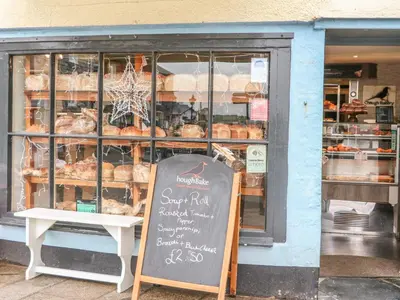 a bakery with a sign in front of a window at Lantern Cottage in Padstow