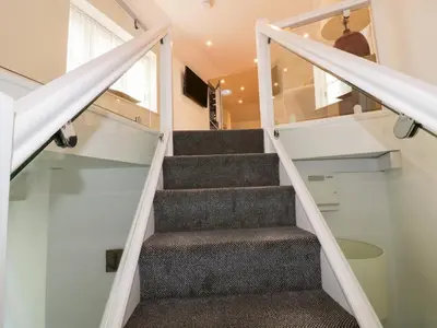 a staircase in a tiny house at Fishermans Loft in Mevagissey