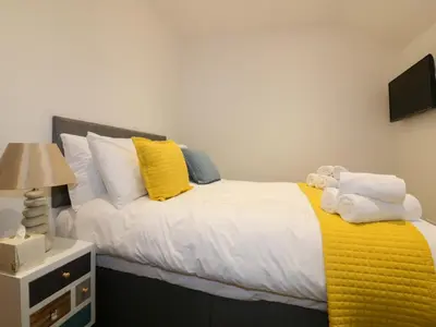 a bedroom with a bed with towels on it at Fishermans Loft in Mevagissey