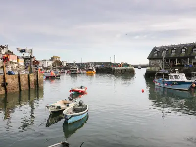 a group of boats in the water in a harbor at Fishermans Loft in Mevagissey