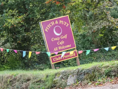 a sign for a curry court cafe with flags at Phenests in Falmouth