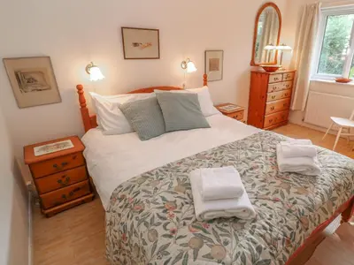 a bedroom with a bed with two towels on it at Phenests in Falmouth