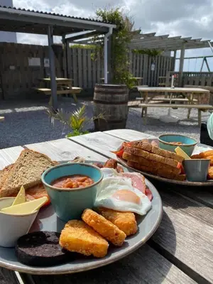 a plate of food with eggs and bread on a table at Wheal Frances-Beautifully Fitted Bungalow Helston Cornwall in Helston