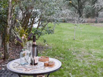 a table with a bottle of wine on top of it at Treen in Lansallos