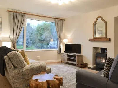 a living room with a couch and a tv at Treen in Lansallos