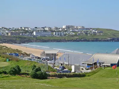a view of a beach with cars parked next to a building at Littlewood in Saint Columb Major