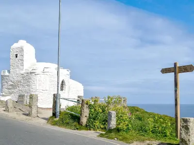 an old white church on the side of a road at Littlewood in Saint Columb Major
