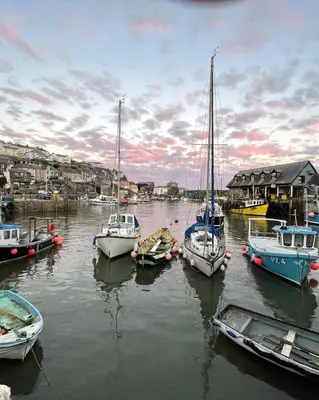 a group of boats are docked in a harbor at Corner Cottage Mevagissey in Mevagissey