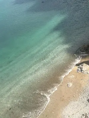 an aerial view of the ocean and the beach at Corner Cottage Mevagissey in Mevagissey