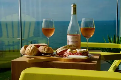 a table with two glasses and a bottle of wine at 29 @ One Lusty Glaze in Newquay