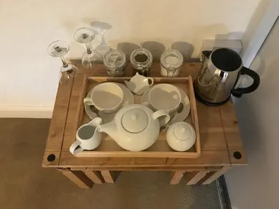 a wooden table with a bunch of dishes on it at Park Farmhouse Bed and Breakfast in Washaway