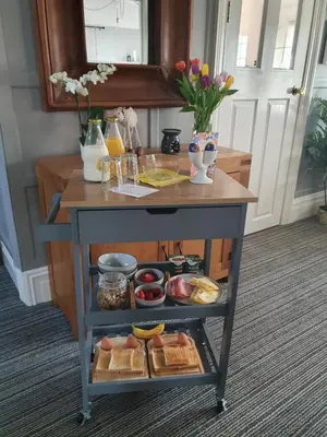 a table with food and drinks on it at Chynoweth Lodge in Newquay