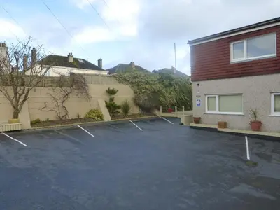 a parking lot in front of a building at Chynoweth Lodge in Newquay