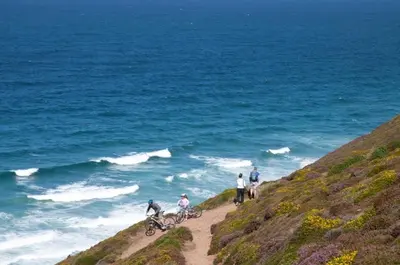 a group of people riding bikes on a beach at The Roundhouse in Redruth