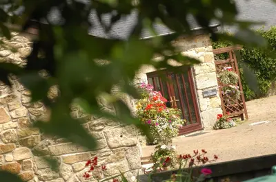 a stone building with a window with flowers on it at The Roundhouse in Redruth