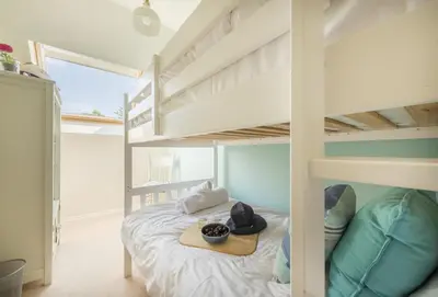 a bedroom with a bunk bed with a tray on it at Curlew's Cwtch in Wadebridge