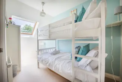 a bedroom with two bunk beds in a room at Curlew's Cwtch in Wadebridge