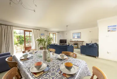 a dining room with a table and chairs at Keepers Cottage in Wadebridge
