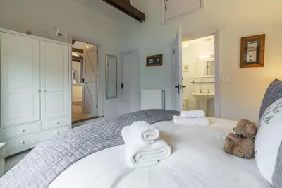a bedroom with a bed with towels on it at Little Gull in Polzeath