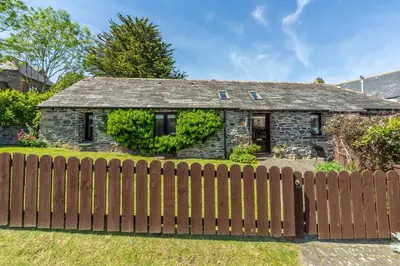 a house with a wooden fence in front of it at Little Gull in Polzeath