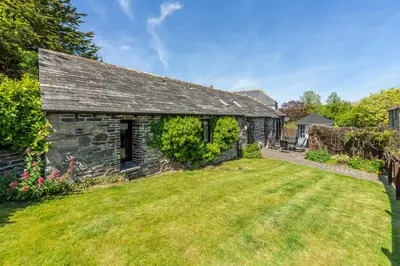 an old stone house with a yard at Little Gull in Polzeath