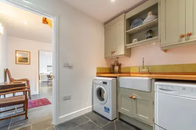 a laundry room with a washer and dryer at No2 The Fish Cellars in Port Isaac