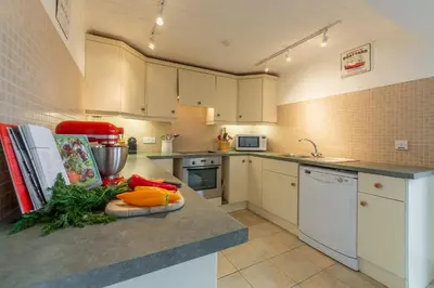 a kitchen with a counter with vegetables on it at Palm Trees in Polzeath