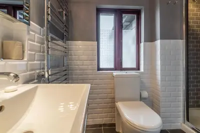 a bathroom with a toilet and a tub and a sink at Pentewan in Polzeath