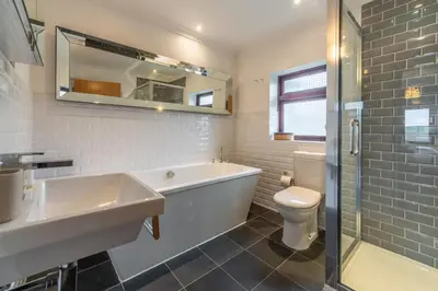 a bathroom with a tub and a toilet and a sink at Pentewan in Polzeath