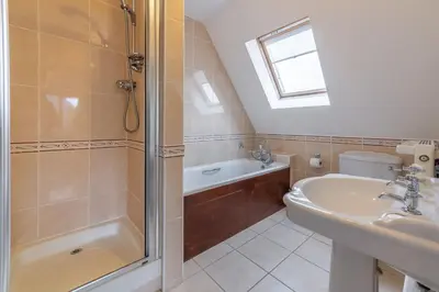 a bathroom with a shower and a sink at September Cottage in Wadebridge