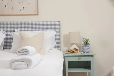 a bedroom with a bed with towels on it at The Nineteenth in Wadebridge