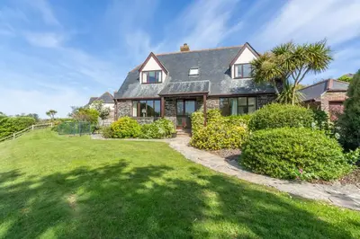 a house with a green lawn in front of it at The Nineteenth in Wadebridge