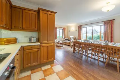 a kitchen and dining room with a table and chairs at Webbs Retreat in Wadebridge