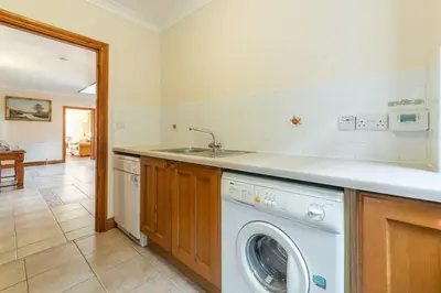 a kitchen with a washing machine and a sink at Webbs Retreat in Wadebridge