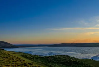 a view of a body of water at sunset at Webbs Retreat in Wadebridge