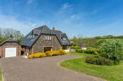a large brick house with a driveway at Webbs Retreat in Wadebridge