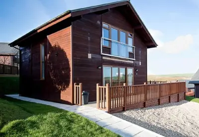 a house with a wooden fence in front of it at Retallack Resort by Away Resorts in Padstow