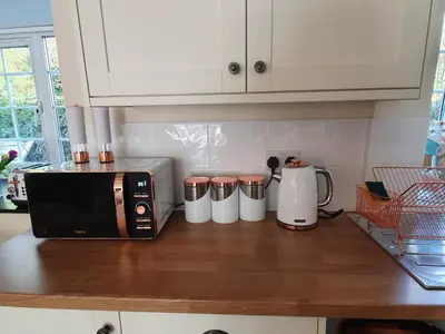 a kitchen counter with a coffee maker and a microwave at No 4 Trelawney Apartment - Onsite Bar - Restaurant - Horse Riding in Menheniot