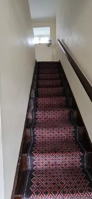an empty staircase in a building with red carpet at No 4 Trelawney Apartment - Onsite Bar - Restaurant - Horse Riding in Menheniot