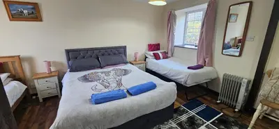 a bedroom with a bed with a elephant on it at No 4 Trelawney Apartment - Onsite Bar - Restaurant - Horse Riding in Menheniot
