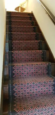 a set of stairs with colorful designs on them at No 4 Trelawney Apartment - Onsite Bar - Restaurant - Horse Riding in Menheniot
