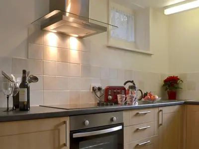 a kitchen with a sink and a stove top oven at Isolda's - Ukc3905 in Lostwithiel