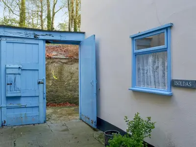 a blue door and a window on the side of a building at Isolda's - Ukc3905 in Lostwithiel