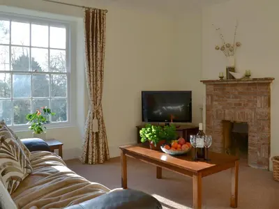 a living room with a couch and a fireplace at Tristan's - Ukc3906 in Lostwithiel