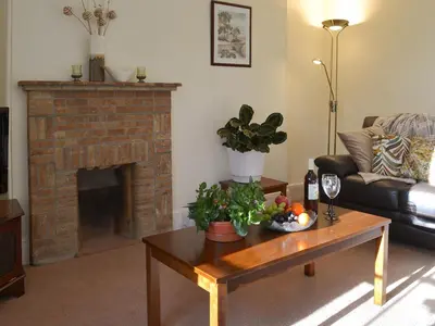 a living room with a fireplace and a coffee table at Tristan's - Ukc3906 in Lostwithiel