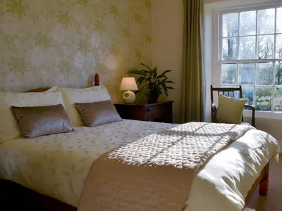 a bedroom with a bed and a window at Tristan's - Ukc3906 in Lostwithiel