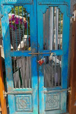 an old blue door with a metal gate at Sailaway in Carbis Bay