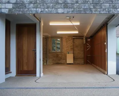 an empty hallway with a door and a brick wall at Padstow Escapes - The Long Room Luxury Apartment in Padstow
